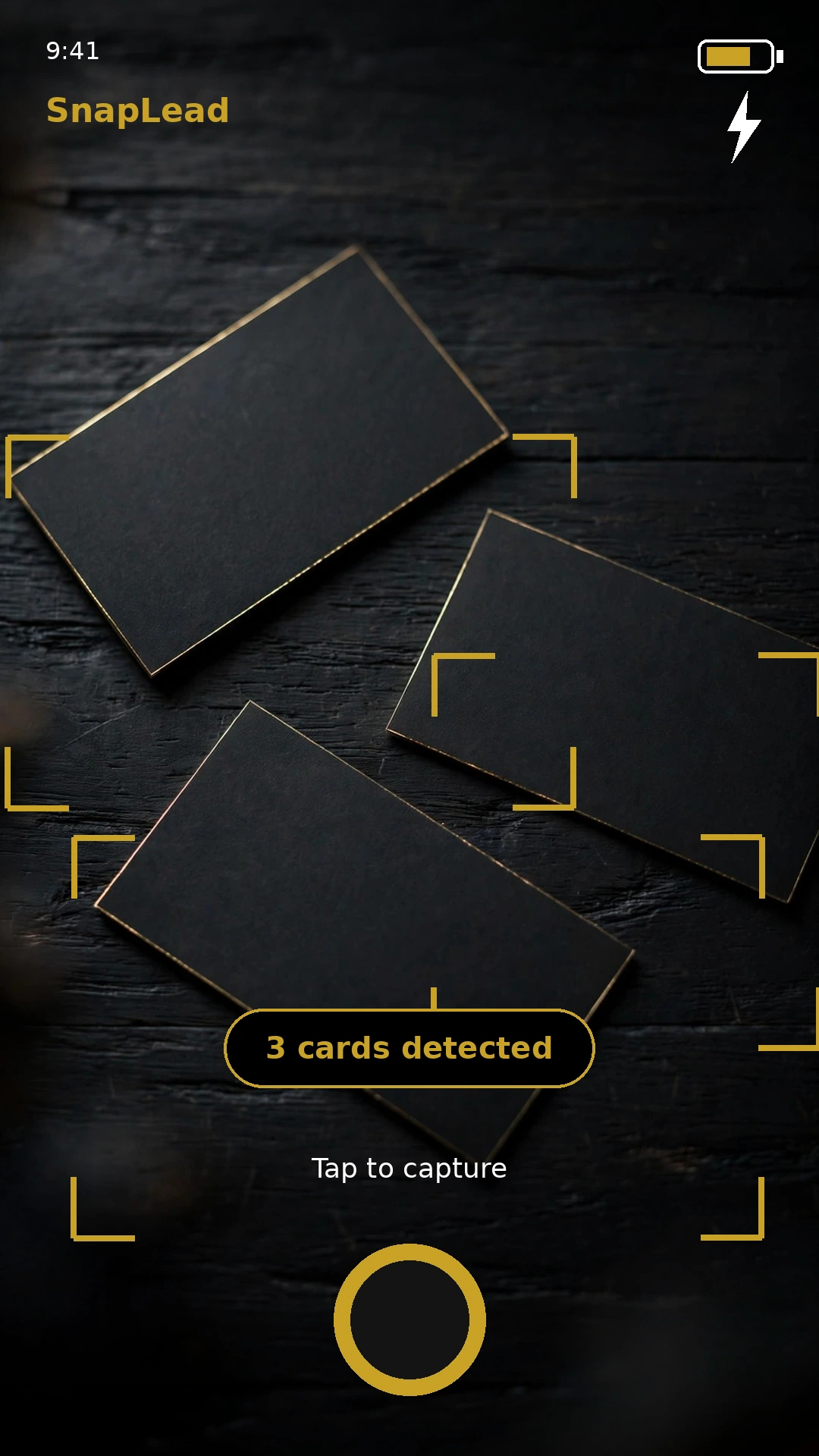 SnapLead camera viewfinder detecting 3 business cards on a table